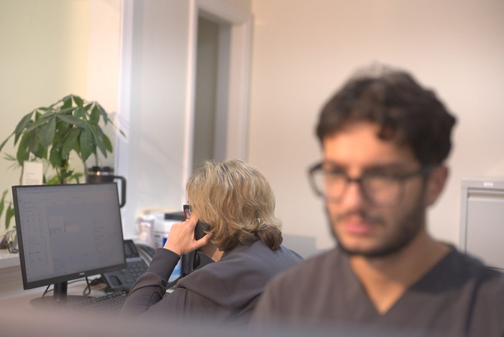 313 Dental front desk team assisting patients by phone