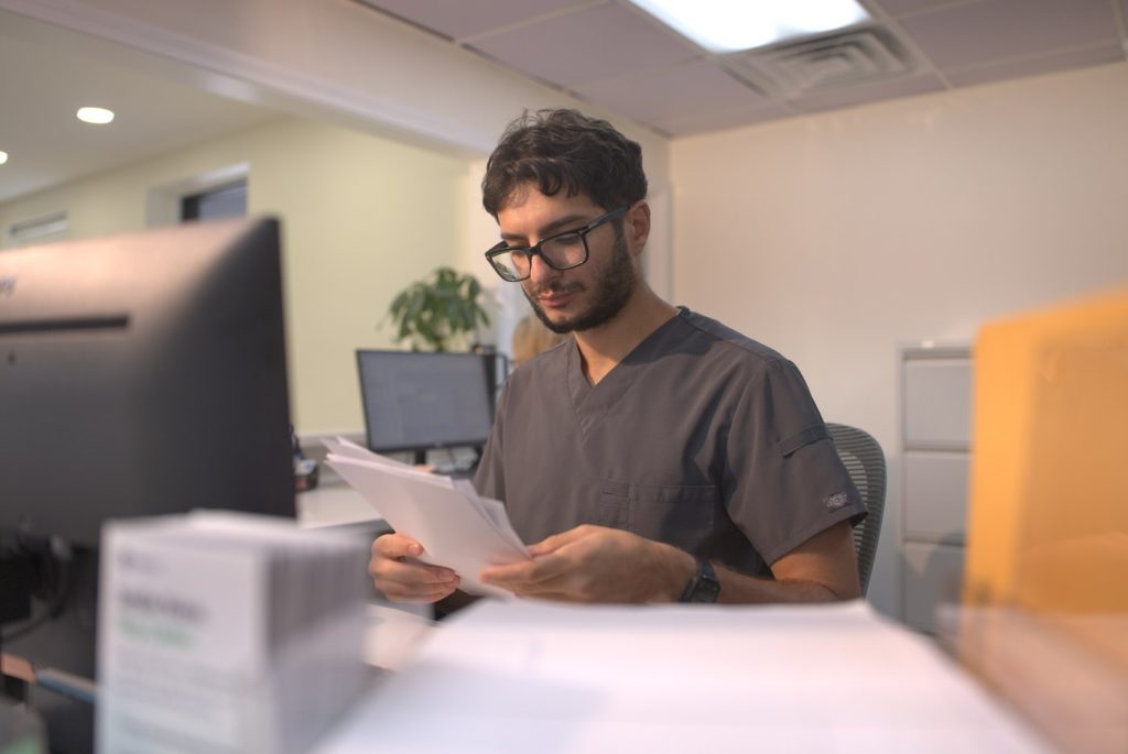 313 Dental team member reviewing patient paperwork